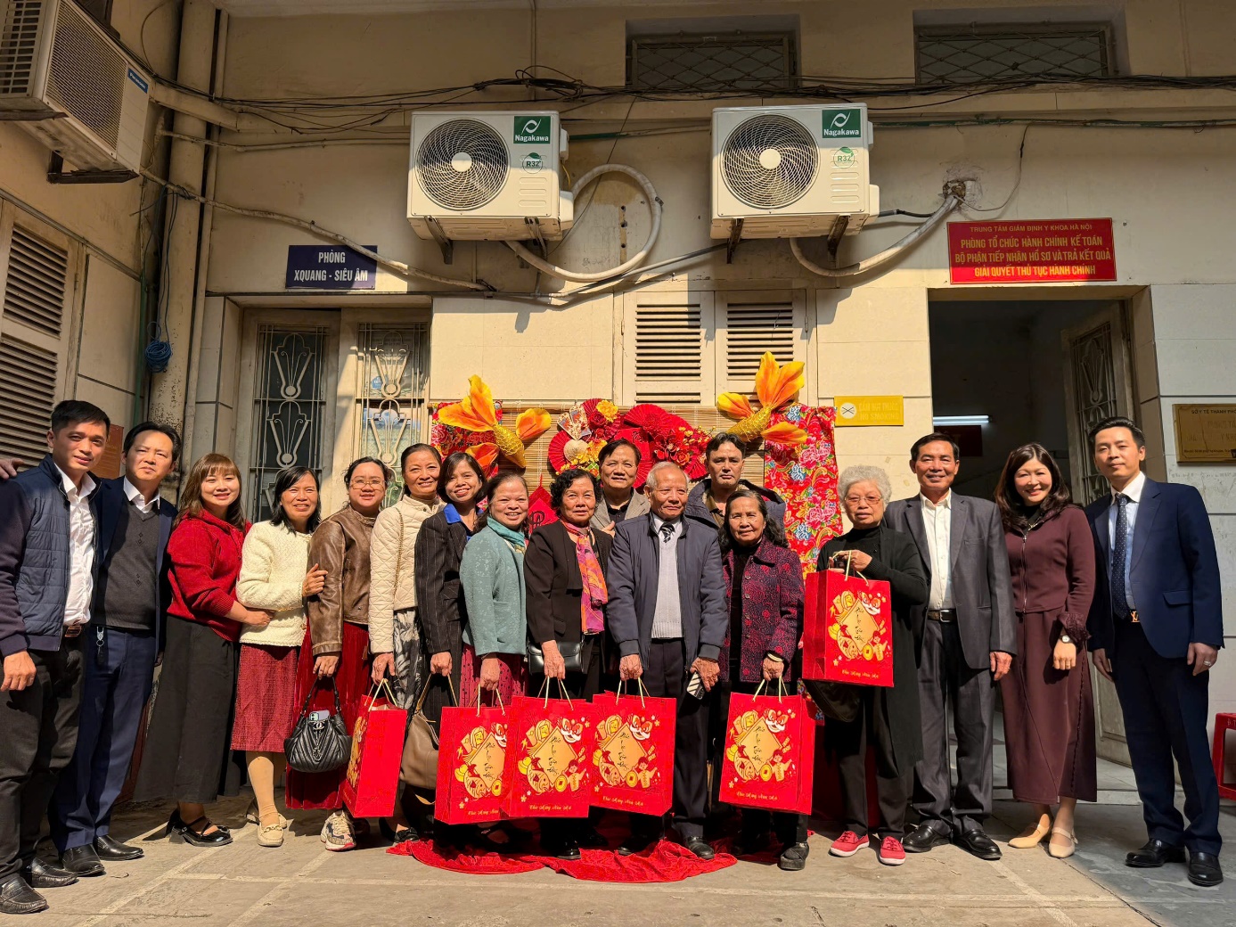 '''A group of people posing for a photo
Description automatically generated'''